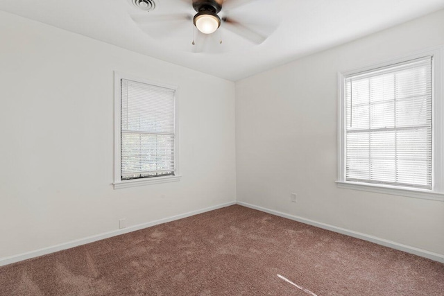 spare room featuring carpet and ceiling fan