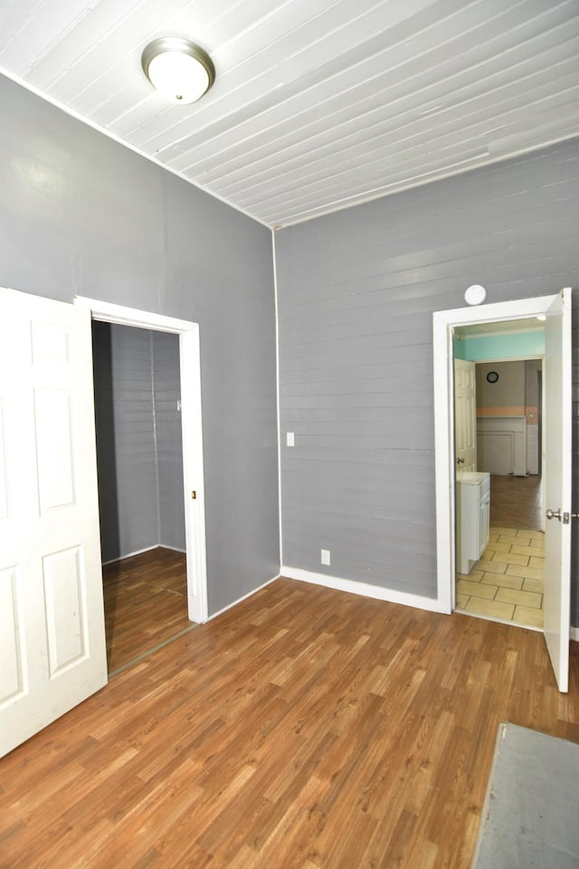 unfurnished bedroom with light hardwood / wood-style flooring and a closet