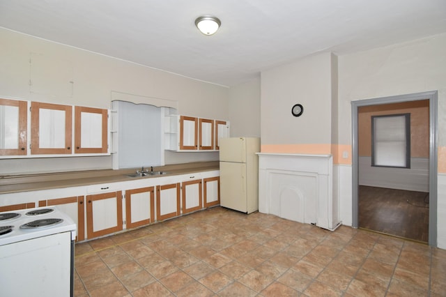 kitchen with white cabinetry, sink, and white appliances