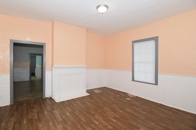 empty room with dark hardwood / wood-style flooring