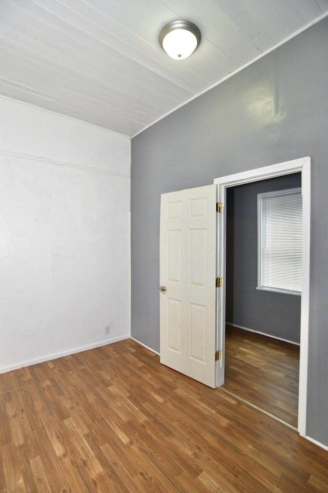 unfurnished room with hardwood / wood-style floors