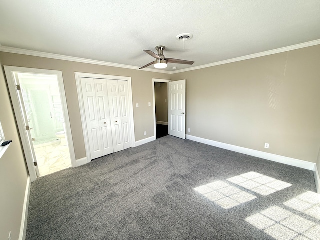 unfurnished bedroom featuring connected bathroom, baseboards, ornamental molding, and carpet floors
