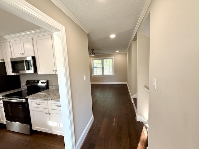 hallway featuring a textured ceiling, dark wood-type flooring, recessed lighting, crown molding, and baseboards