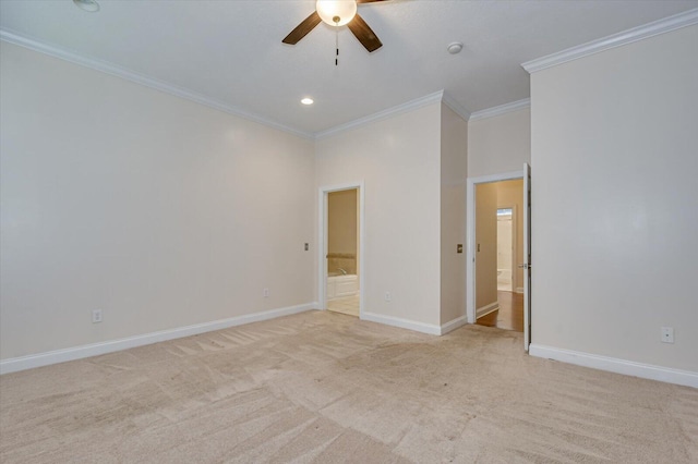 spare room featuring ceiling fan, ornamental molding, and light carpet