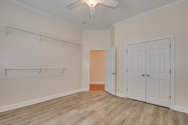 unfurnished bedroom featuring ceiling fan, light wood-type flooring, and ornamental molding