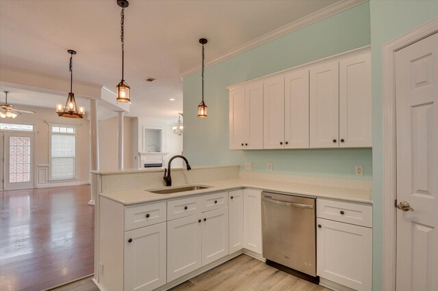 kitchen with hanging light fixtures, white cabinetry, sink, and stainless steel dishwasher