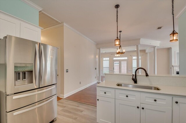 kitchen featuring sink, white cabinets, and stainless steel refrigerator with ice dispenser