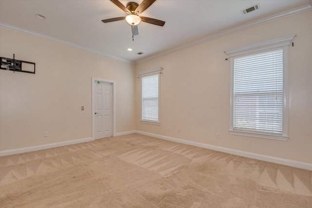 carpeted empty room featuring ceiling fan and crown molding