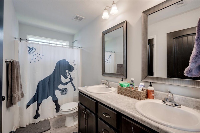 bathroom featuring a sink, toilet, double vanity, and visible vents