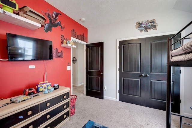 bedroom featuring baseboards, carpet flooring, and a textured ceiling