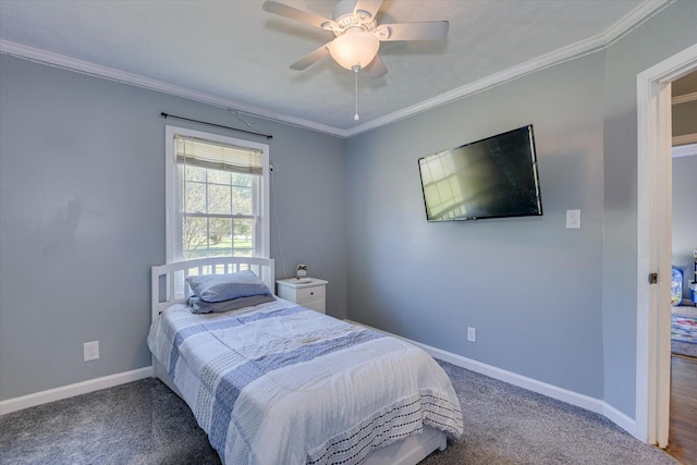 carpeted bedroom featuring ceiling fan and crown molding