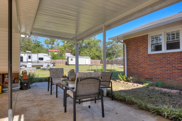 view of patio featuring a storage unit