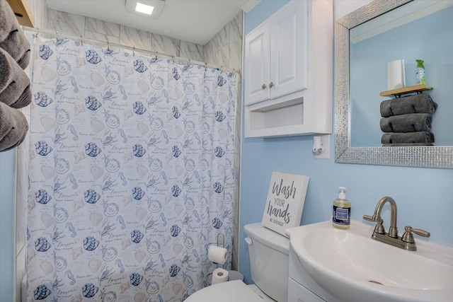 bathroom featuring walk in shower, vanity, and toilet