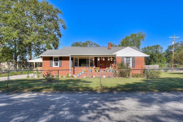 ranch-style house featuring covered porch and a front lawn