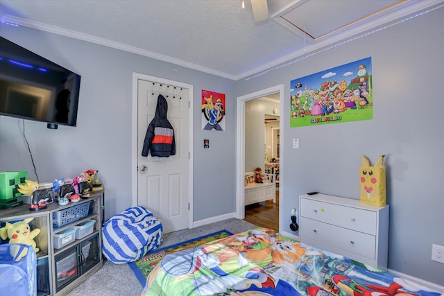 bedroom with ceiling fan, crown molding, and carpet floors