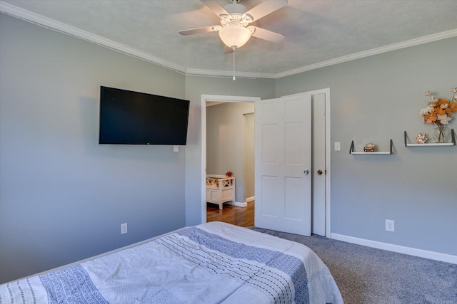 bedroom featuring ceiling fan, crown molding, a textured ceiling, and dark colored carpet