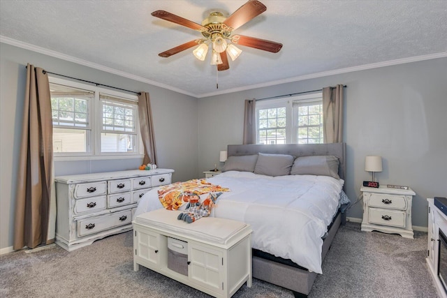 carpeted bedroom with a textured ceiling, ceiling fan, and crown molding