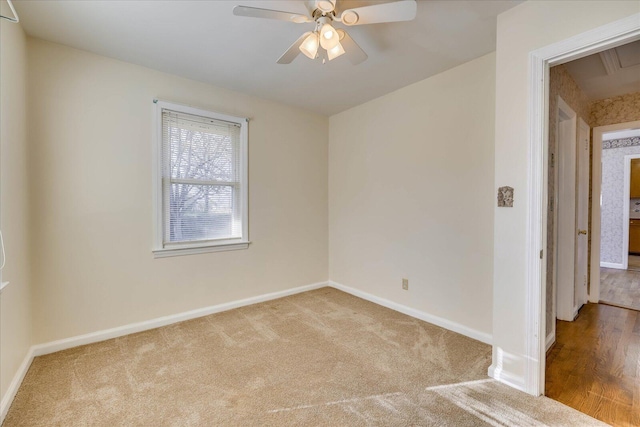 spare room with carpet, baseboards, and a ceiling fan