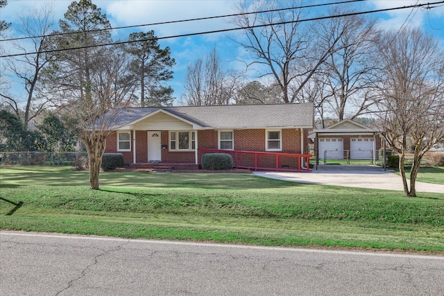 view of front of home featuring brick siding, fence, a front lawn, and an outdoor structure