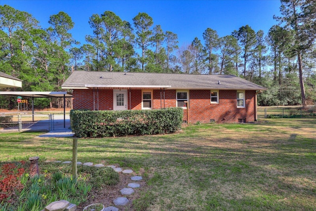 back of house featuring a lawn, crawl space, fence, a carport, and brick siding