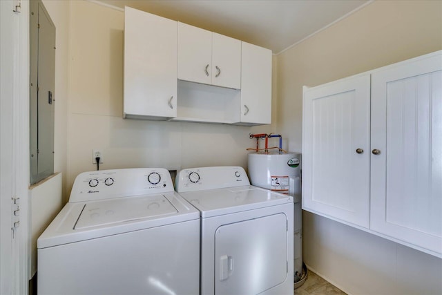 clothes washing area featuring water heater, separate washer and dryer, and cabinet space