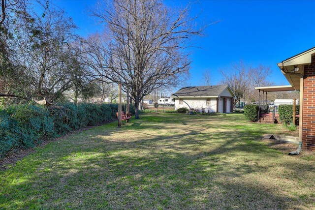 view of yard with an outdoor structure and fence