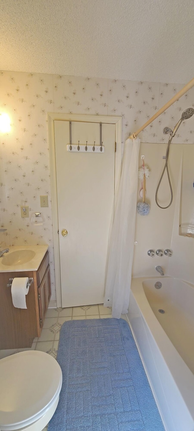 bathroom with wallpapered walls, vanity, tile patterned floors, a textured ceiling, and shower / bathtub combination with curtain