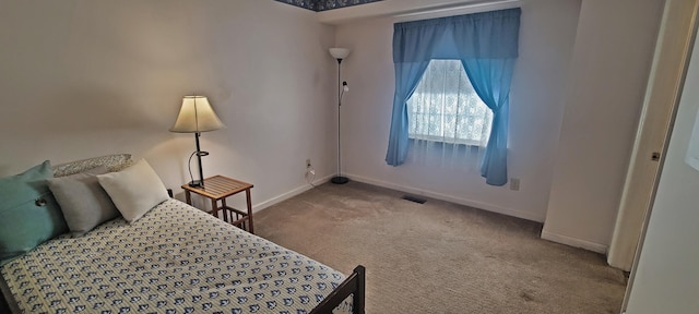 bedroom with visible vents, carpet, and baseboards