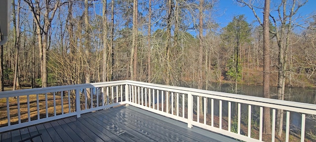 wooden terrace featuring a forest view