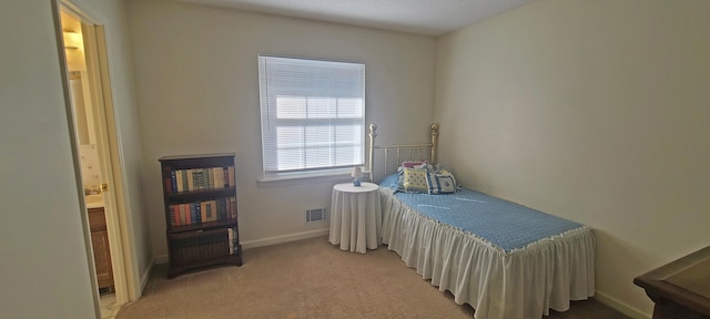 bedroom featuring visible vents, light colored carpet, and baseboards