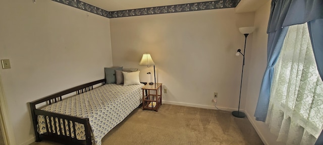 carpeted bedroom with baseboards