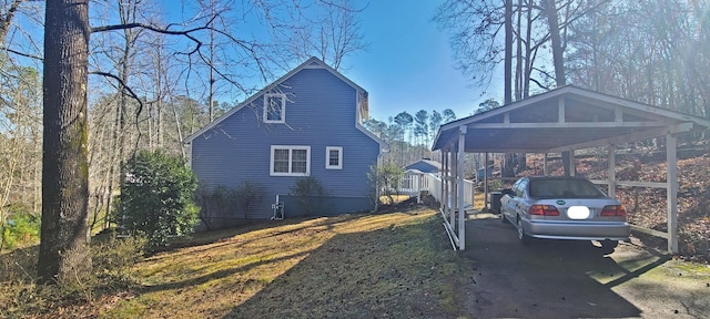 view of home's exterior with a carport and driveway