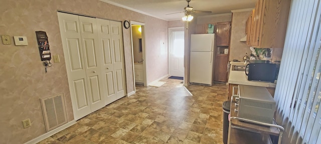 kitchen featuring baseboards, visible vents, freestanding refrigerator, ornamental molding, and black microwave