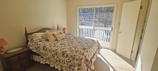 bedroom featuring multiple windows, carpet flooring, and access to outside