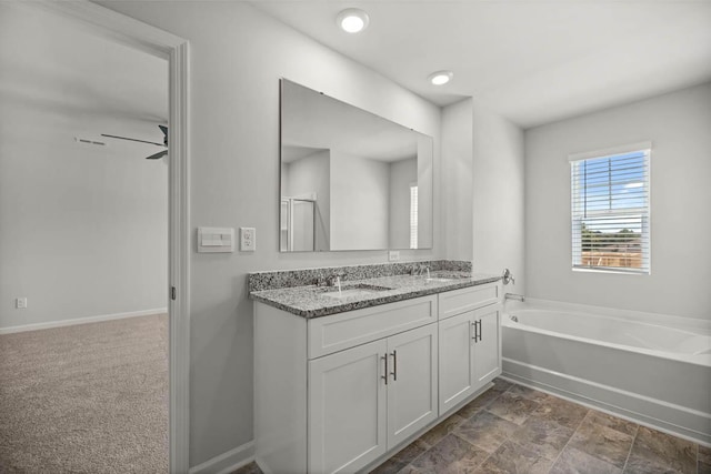 1255 Birch Cir, Grovetown, GA 30813 - bathroom with double vanity, a garden tub, and baseboards