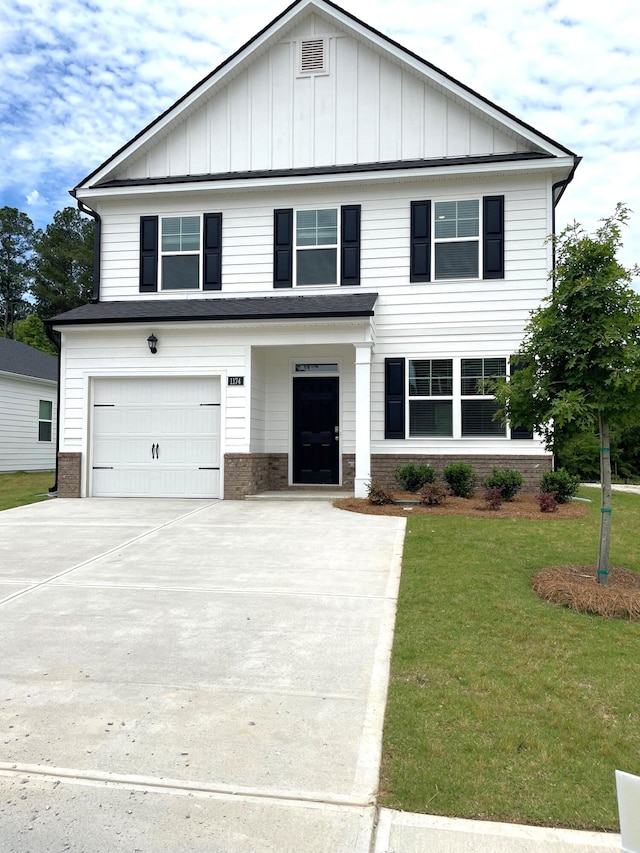 view of front of house with brick siding, board and batten siding, a front lawn, driveway, and an attached garage