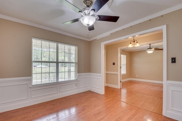 spare room featuring crown molding, wood-type flooring, and a notable chandelier