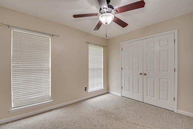 unfurnished bedroom with a closet, ceiling fan, and light colored carpet