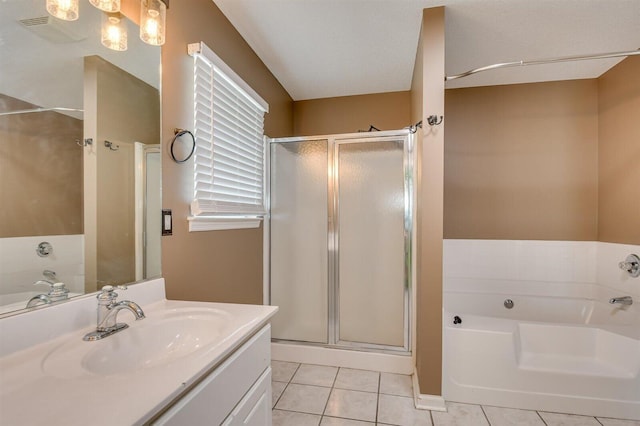 bathroom with tile patterned floors, separate shower and tub, and vanity