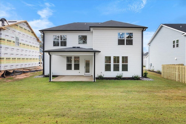 rear view of house with a patio area and a yard