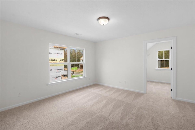 spare room with light colored carpet