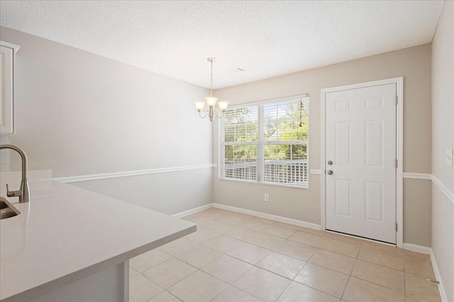 612 Creek Bottom Trl, Grovetown, GA 30813 - unfurnished dining area with a chandelier, light tile patterned flooring, and a textured ceiling