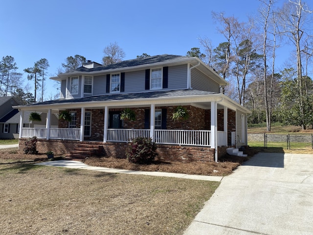 country-style home featuring covered porch, brick siding, central AC unit, and a gate