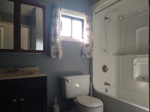 full bathroom featuring vanity, bathing tub / shower combination, and toilet