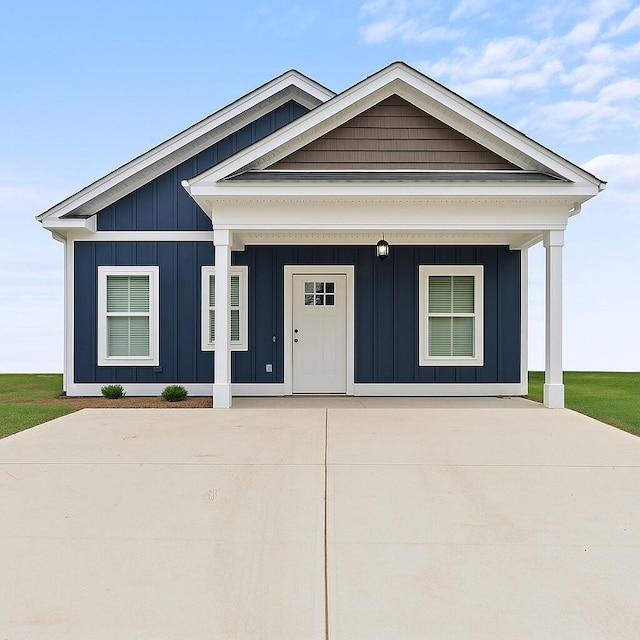 241 Walker St, Augusta, GA 30901 - view of front of house with board and batten siding, driveway, and a porch