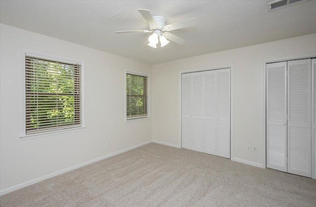 327 Joshua Tree Dr, Martinez, GA 30907 - unfurnished bedroom featuring multiple closets, carpet, baseboards, and ceiling fan
