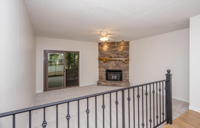327 Joshua Tree Dr, Martinez, GA 30907 - unfurnished living room featuring ceiling fan, a fireplace, wood finished floors, baseboards, and carpet floors