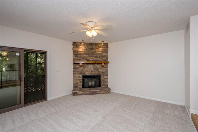 327 Joshua Tree Dr, Martinez, GA 30907 - unfurnished living room featuring ceiling fan, carpet flooring, baseboards, a fireplace, and a textured ceiling