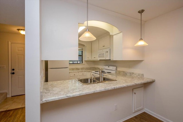 327 Joshua Tree Dr, Martinez, GA 30907 - kitchen featuring white appliances, a peninsula, crown molding, wood finished floors, and light countertops