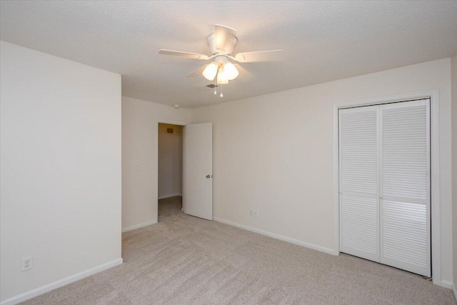 327 Joshua Tree Dr, Martinez, GA 30907 - unfurnished bedroom with light carpet, a closet, baseboards, ceiling fan, and a textured ceiling